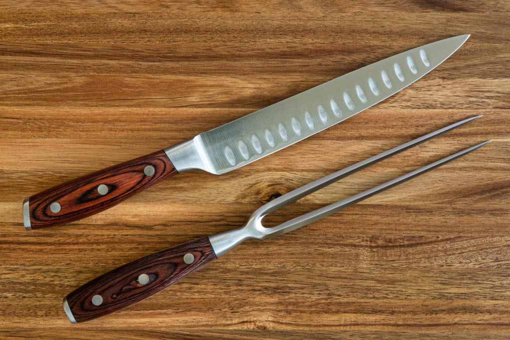 carving-knife-and-fork-carving-set-on-a-wood-cutting-board